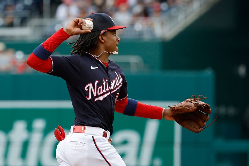 Jul 9, 2023; Washington, District of Columbia, USA; Washington Nationals shortstop CJ Abrams (5) makes a throw to first base after fielding a ground ball hit by Texas Rangers second baseman Marcus Semien (2) during the fourth inning at Nationals Park. Mandatory Credit: Geoff Burke-USA TODAY Sports