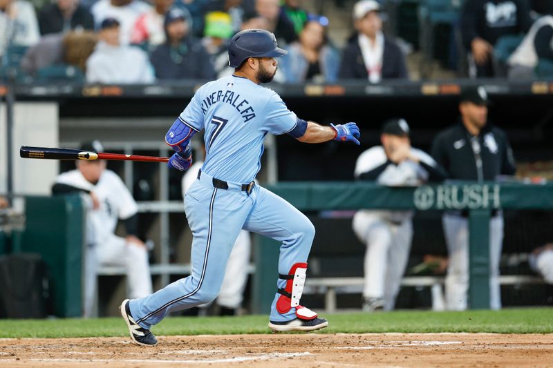 May 27, 2024; Chicago, Illinois, USA; Toronto Blue Jays third baseman Isiah Kiner-Falefa (7) hits an RBI-single against the Chicago White Sox during the fourth inning at Guaranteed Rate Field. Mandatory Credit: Kamil Krzaczynski-USA TODAY Sports