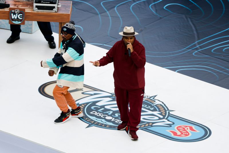 Jan 1, 2024; Seattle, Washington, USA; Sir Mix-A-Lot, right, performs before the first period of the 2024 Winter Classic ice hockey game between the Vegas Golden Knights and Seattle Kraken at T-Mobile Park. Mandatory Credit: Joe Nicholson-USA TODAY Sports