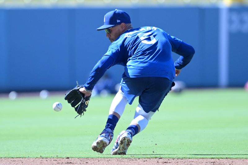 Aug 5, 2024; Los Angeles, California, USA;  Los Angeles Dodgers second baseman Mookie Betts (50) fields ground balls prior to the game against the Philadelphia Phillies at Dodger Stadium. Mandatory Credit: Jayne Kamin-Oncea-USA TODAY Sports