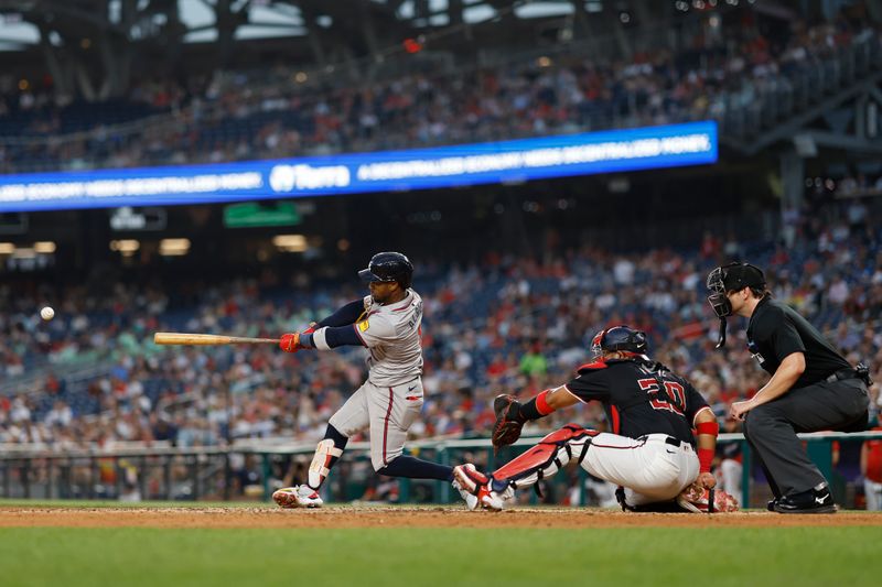 Jun 6, 2024; Washington, District of Columbia, USA; Atlanta Braves second baseman Ozzie Albies (1) hits a double against the Washington Nationals during the eighth inning at Nationals Park. Mandatory Credit: Geoff Burke-USA TODAY Sports