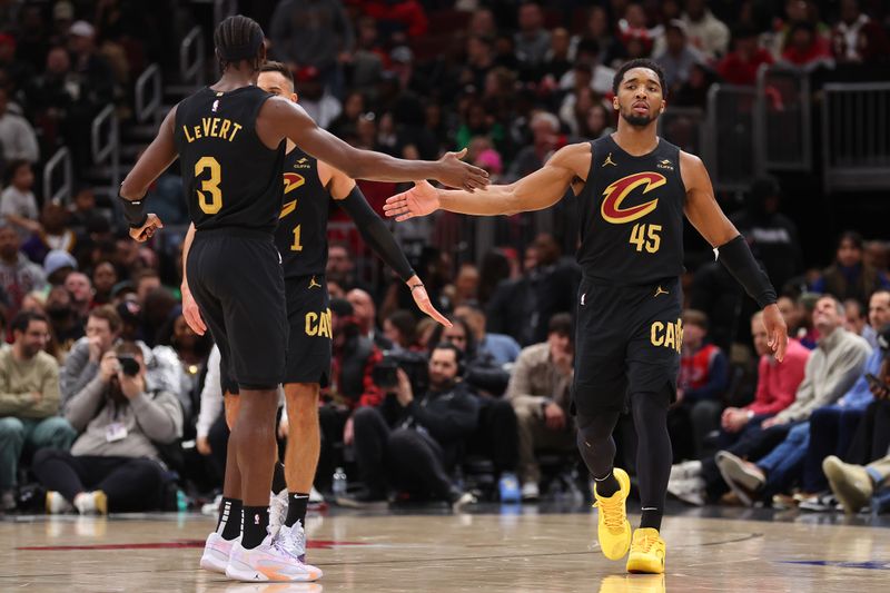 CHICAGO, ILLINOIS - FEBRUARY 28: Donovan Mitchell #45 of the Cleveland Cavaliers high fives Caris LeVert #3 against the Chicago Bulls in overtime at the United Center on February 28, 2024 in Chicago, Illinois. NOTE TO USER: User expressly acknowledges and agrees that, by downloading and or using this photograph, User is consenting to the terms and conditions of the Getty Images License Agreement. (Photo by Michael Reaves/Getty Images)