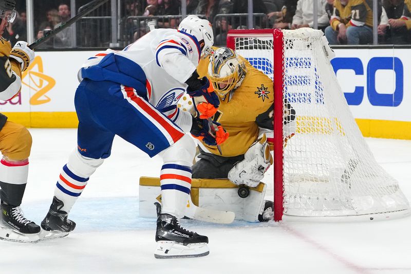May 6, 2025; Las Vegas, Nevada, USA; Vegas Golden Knights goaltender Adin Hill (33) makes a save against Edmonton Oilers left wing Evander Kane (91) during the first period of game one of the second round of the 2025 Stanley Cup Playoffs at T-Mobile Arena. Mandatory Credit: Stephen R. Sylvanie-Imagn Images