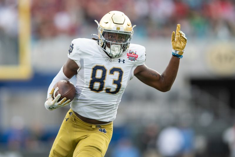 Dec 30, 2022; Jacksonville, FL, USA; Notre Dame Fighting Irish wide receiver Jayden Thomas (83) runs after the catch against the South Carolina Gamecocks in the first quarter in the 2022 Gator Bowl at TIAA Bank Field. Mandatory Credit: Jeremy Reper-USA TODAY Sports