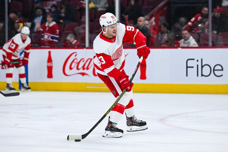 Dec 2, 2023; Montreal, Quebec, CAN; Detroit Red Wings right wing Alex DeBrincat (93) shoots a puck during warm up before the game against the Montreal Canadiens at Bell Centre. Mandatory Credit: David Kirouac-USA TODAY Sports