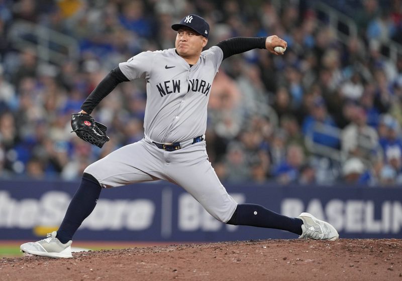 Apr 17, 2024; Toronto, Ontario, CAN; New York Yankees pitcher Victor Gonzalez (47) throws a pitch against the Toronto Blue Jays during the eighth inning at Rogers Centre. Mandatory Credit: Nick Turchiaro-USA TODAY Sports