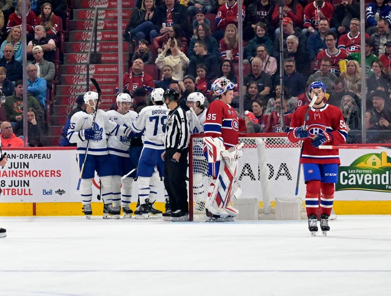 Apr 6, 2024; Montreal, Quebec, CAN; Toronto Maple Leafs forward Matthew Knies (23) celebrates with teammates after scoring a goal against Montreal Canadiens goalie Sam Montembeault (35) during the second period at the Bell Centre. Mandatory Credit: Eric Bolte-USA TODAY Sports