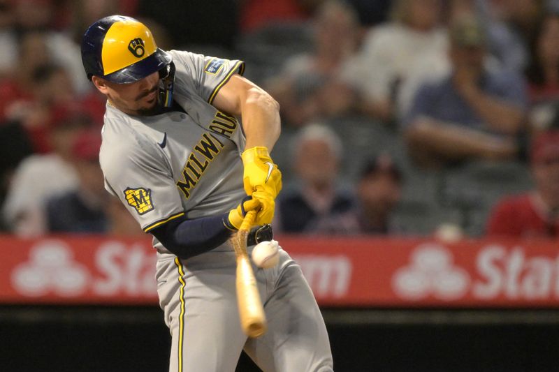 Jun 19, 2024; Anaheim, California, USA;  Milwaukee Brewers shortstop Willy Adames (27) breaks his bat on a RBI single in the eighth inning against the Los Angeles Angels at Angel Stadium. Mandatory Credit: Jayne Kamin-Oncea-USA TODAY Sports