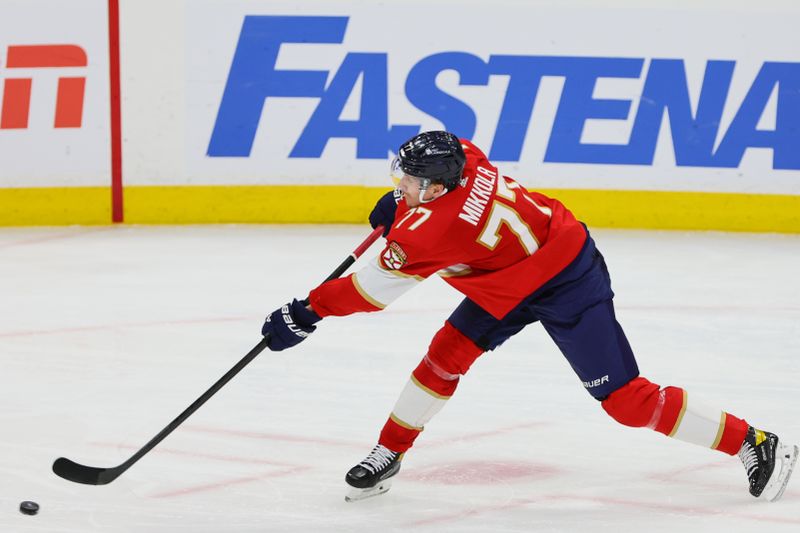 Apr 23, 2024; Sunrise, Florida, USA; Florida Panthers defenseman Niko Mikkola (77) shoots the puck against the Tampa Bay Lightning during the third period in game two of the first round of the 2024 Stanley Cup Playoffs at Amerant Bank Arena. Mandatory Credit: Sam Navarro-USA TODAY Sports