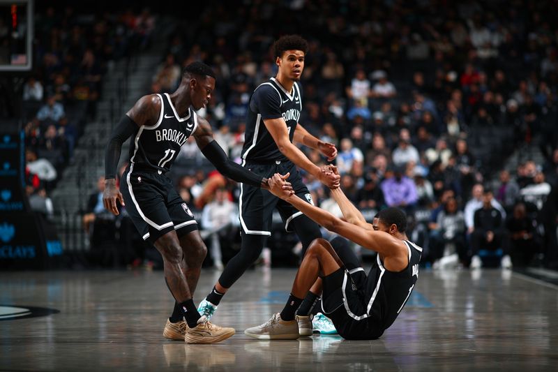 BROOKLYN, NY - MARCH 4: Dennis Schroder #17 and Cameron Johnson #2 help up Mikal Bridges #1 of the Brooklyn Nets during the game against the Memphis Grizzlies on March 4, 2024 at Barclays Center in Brooklyn, New York. NOTE TO USER: User expressly acknowledges and agrees that, by downloading and or using this Photograph, user is consenting to the terms and conditions of the Getty Images License Agreement. Mandatory Copyright Notice: Copyright 2024 NBAE (Photo by David L. Nemec/NBAE via Getty Images)