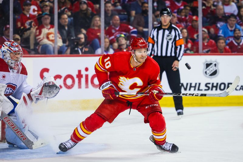 Mar 16, 2024; Calgary, Alberta, CAN; Calgary Flames center Jonathan Huberdeau (10) controls the puck in front of Montreal Canadiens goaltender Cayden Primeau (30) during the second period at Scotiabank Saddledome. Mandatory Credit: Sergei Belski-USA TODAY Sports