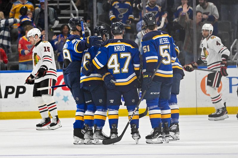 Apr 10, 2024; St. Louis, Missouri, USA;  St. Louis Blues defenseman Torey Krug (47) is congratulated by teammates after scoring against the Chicago Blackhawks during the first period at Enterprise Center. Mandatory Credit: Jeff Curry-USA TODAY Sports