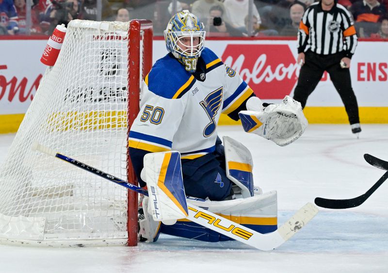 Feb 11, 2024; Montreal, Quebec, CAN; St.Louis Blues goalie Jordan Binnington (50) tracks the puck during the second period of the game against the Montreal Canadiens at the Bell Centre. Mandatory Credit: Eric Bolte-USA TODAY Sports