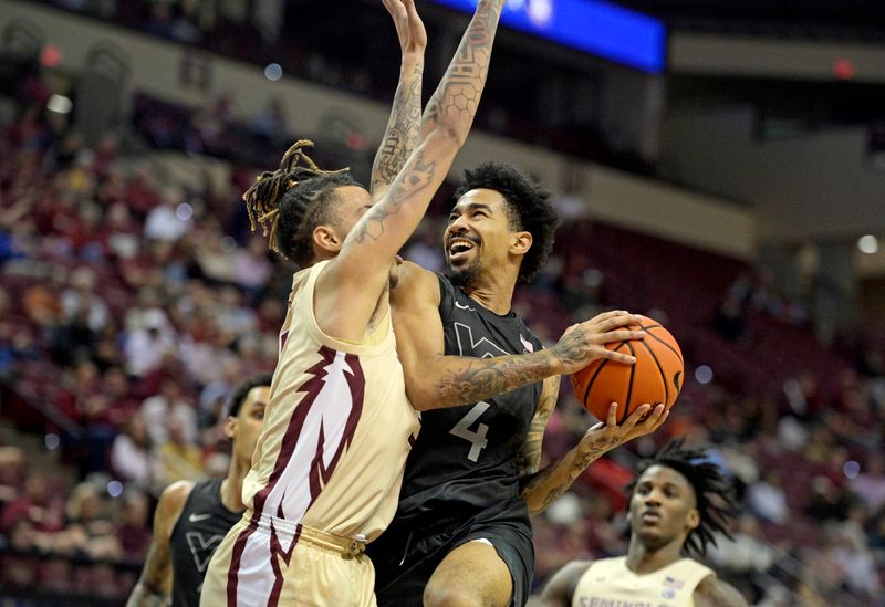 Jan 6, 2024; Tallahassee, Florida, USA; Virginia Tech Hokies forward Mekhi Long (4) shoots the ball against Florida State Seminoles forward De Ante Green (5) during the second half at Donald L. Tucker Center. Mandatory Credit: Melina Myers-USA TODAY Sports