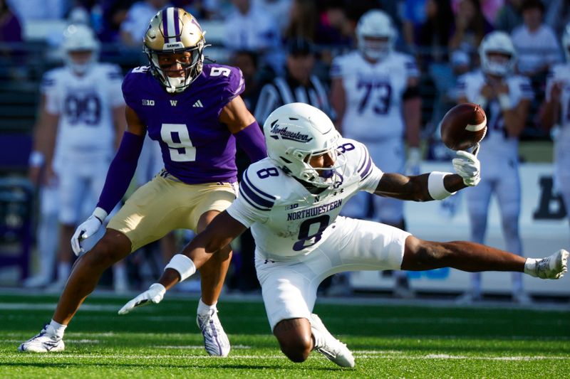 Sep 21, 2024; Seattle, Washington, USA; Northwestern Wildcats wide receiver A.J. Henning (8) drops a pass while under coverage from Washington Huskies cornerback Thaddeus Dixon (9) during the first quarter at Alaska Airlines Field at Husky Stadium. Mandatory Credit: Joe Nicholson-Imagn Images