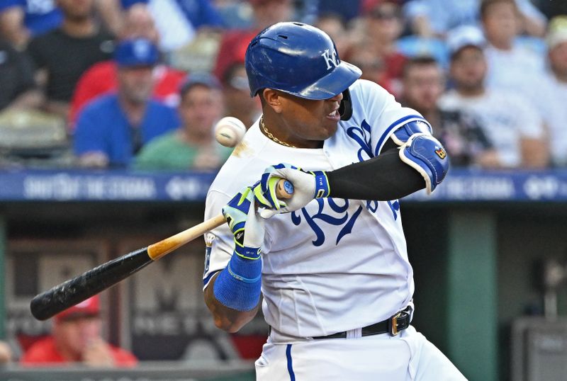 Jun 14, 2023; Kansas City, Missouri, USA;  Kansas City Royals designated hitter Salvador Perez (13) gets hit with a pitch in the third inning against the Cincinnati Reds]at Kauffman Stadium. Mandatory Credit: Peter Aiken-USA TODAY Sports