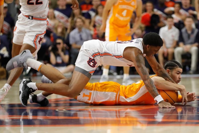 Mar 4, 2023; Auburn, Alabama, USA;  Tennessee Volunteers forward Olivier Nkamhoua (13) and Auburn Tigers guard K.D. Johnson (0) scramble for the ball during the second half at Neville Arena. Mandatory Credit: John Reed-USA TODAY Sports