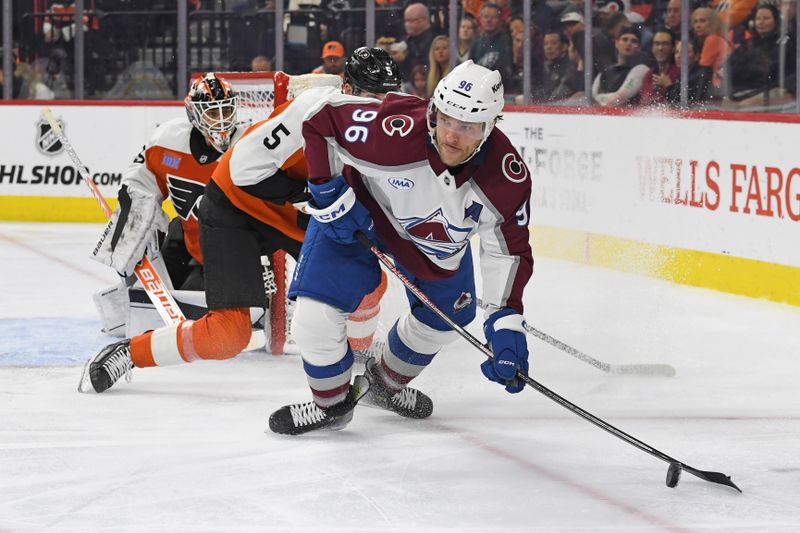 Nov 18, 2024; Philadelphia, Pennsylvania, USA; Colorado Avalanche right wing Mikko Rantanen (96) controls the puck against Philadelphia Flyers defenseman Egor Zamula (5) during the second period at Wells Fargo Center. Mandatory Credit: Eric Hartline-Imagn Images