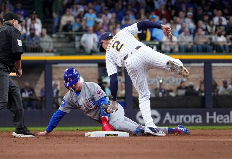 May 4, 2025; Milwaukee, Wisconsin, USA; Milwaukee Brewers second base Brice Turang (2) tags out Chicago Cubs outfielder Pete Crow-Armstrong (4) as he attempt to steal second base in the fifth inning at American Family Field. Mandatory Credit: Michael McLoone-Imagn Images