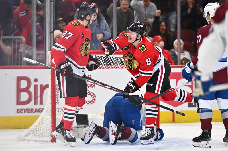 Dec 19, 2023; Chicago, Illinois, USA; Chicago Blackhawks forward Ryan Donato (8) celebrates with forward Lukas Reichel (27) after scoring a goal in the first period against the Colorado Avalanche at United Center. Mandatory Credit: Jamie Sabau-USA TODAY Sports