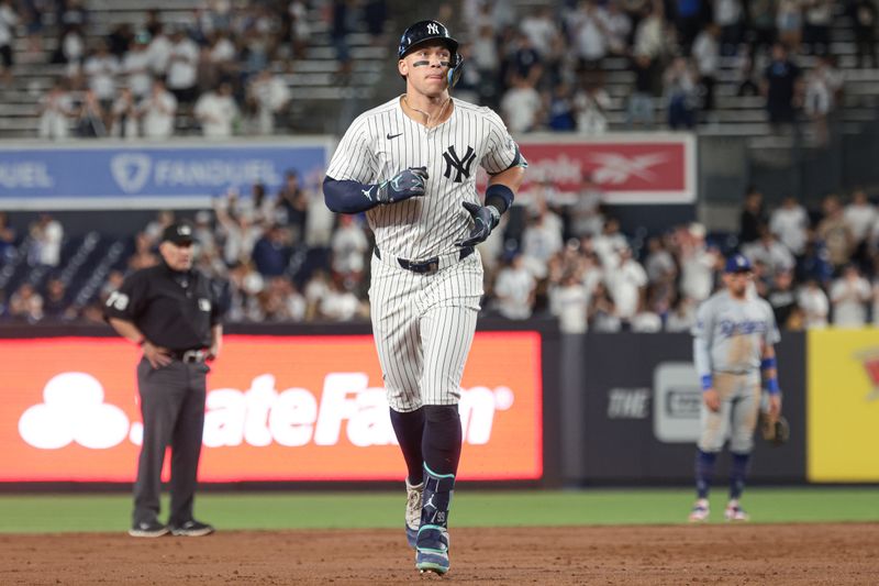 Jun 8, 2024; Bronx, New York, USA; New York Yankees center fielder Aaron Judge (99) runs the bases after his solo home run during the ninth inning against the Los Angeles Dodgers at Yankee Stadium. Mandatory Credit: Vincent Carchietta-USA TODAY Sports