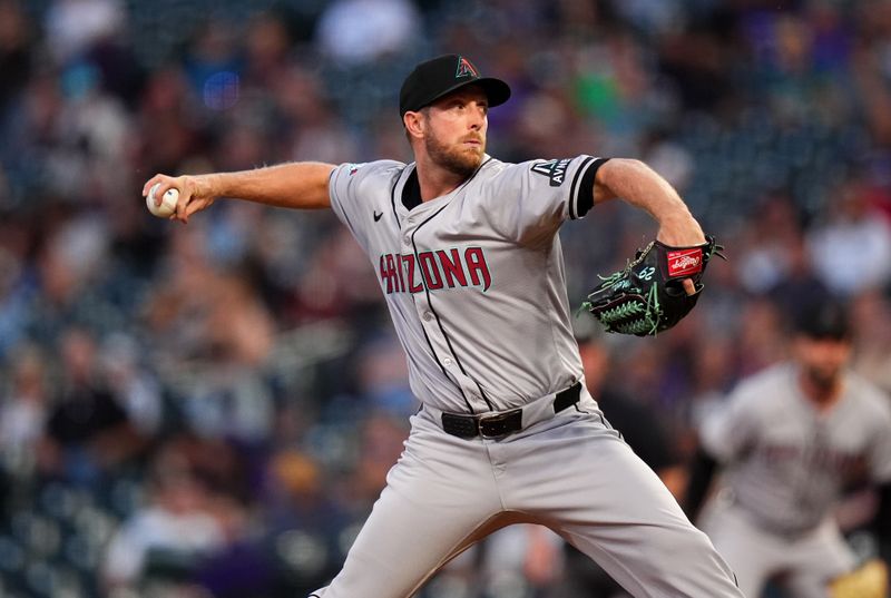 Sep 16, 2024; Denver, Colorado, USA;  Arizona Diamondbacks starting pitcher Merrill Kelly (29) delivers a pitch in the first inning against the Colorado Rockies at Coors Field. Mandatory Credit: Ron Chenoy-Imagn Images