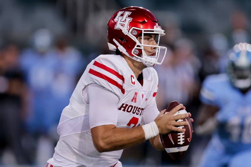 Oct 7, 2021; New Orleans, Louisiana, USA;  Houston Cougars quarterback Clayton Tune (3) scrambles to pass the ball against Tulane Green Wave during the first half at Yulman Stadium. Mandatory Credit: Stephen Lew-USA TODAY Sports