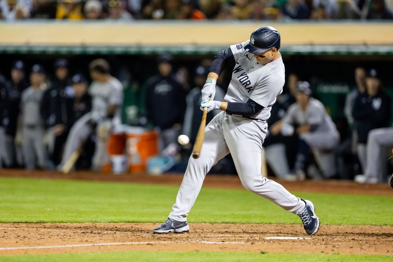 Sep 20, 2024; Oakland, California, USA; New York Yankees catcher Austin Wells (28) singles to advance the runner during the tenth inning against the Oakland Athletics at Oakland-Alameda County Coliseum. Mandatory Credit: Bob Kupbens-Imagn Images