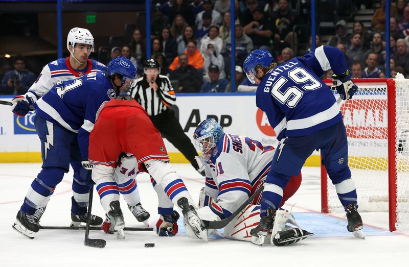Nov 12, 2025; Tampa, Florida, USA; New York Rangers goaltender Igor Shesterkin (31) defends the puck from Tampa Bay Lightning center Jake Guentzel (59) and enter Brayden Point (21) during the third period at Benchmark International Arena. Mandatory Credit: Kim Klement Neitzel-Imagn Images