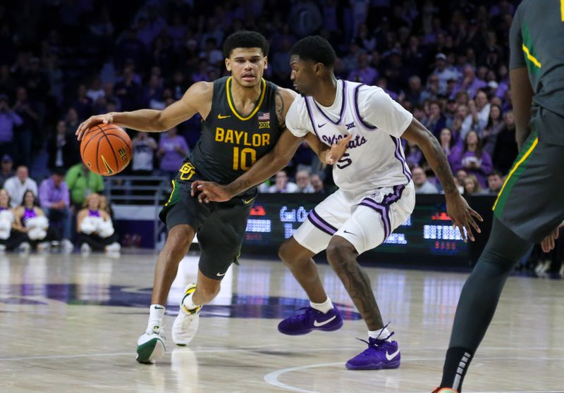 Jan 16, 2024; Manhattan, Kansas, USA; Baylor Bears guard RayJ Dennis (10) is guarded by Kansas State Wildcats guard Cam Carter (5) during overtime at Bramlage Coliseum. Mandatory Credit: Scott Sewell-USA TODAY Sports