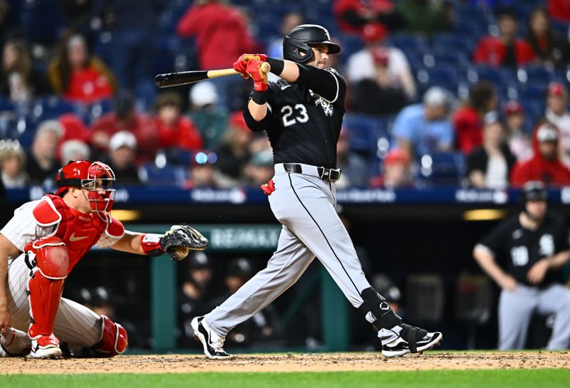 Apr 20, 2024; Philadelphia, Pennsylvania, USA; Chicago White Sox outfielder Andrew Benintendi (23) hits a single against the Philadelphia Phillies in the ninth inning at Citizens Bank Park. Mandatory Credit: Kyle Ross-USA TODAY Sports