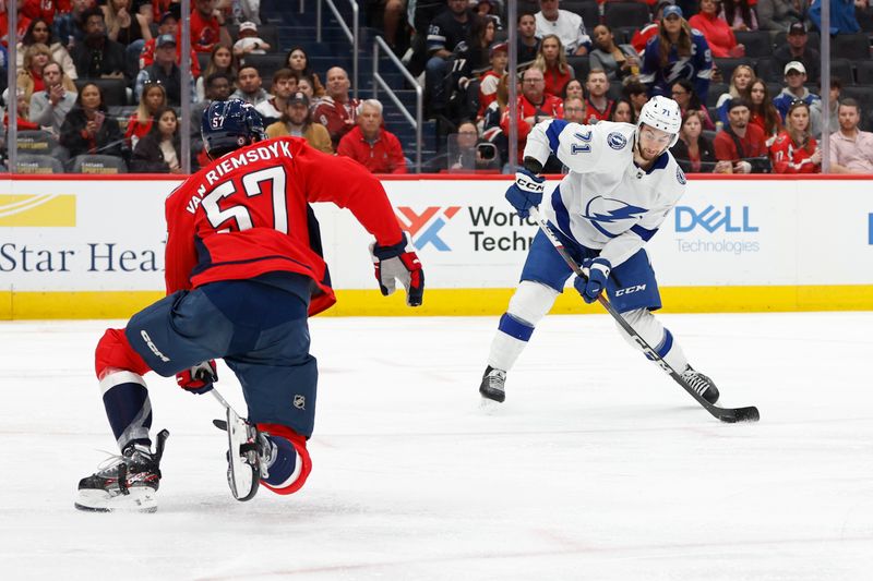 Apr 13, 2024; Washington, District of Columbia, USA; Tampa Bay Lightning center Anthony Cirelli (71) shoots the puck as Washington Capitals defenseman Trevor van Riemsdyk (57) defends in the second period at Capital One Arena. Mandatory Credit: Geoff Burke-USA TODAY Sports