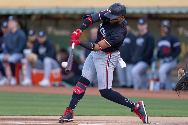 Jun 21, 2024; Oakland, California, USA; Minnesota Twins shortstop Willi Castro (50) hits a double against the Oakland Athletics during the first inning at Oakland-Alameda County Coliseum. Mandatory Credit: Stan Szeto-USA TODAY Sports