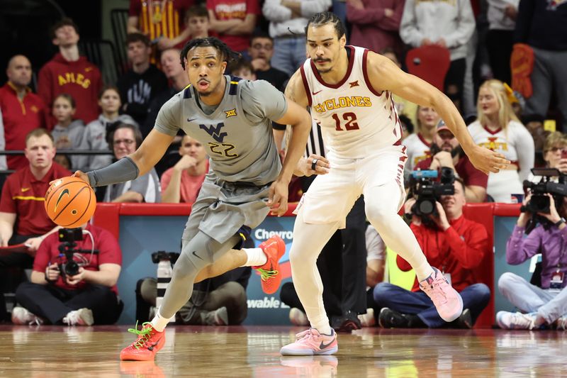 Feb 24, 2024; Ames, Iowa, USA; West Virginia Mountaineers forward Josiah Harris (22) beats Iowa State Cyclones forward Robert Jones (12) down the court during the second half at James H. Hilton Coliseum. Mandatory Credit: Reese Strickland-USA TODAY Sports