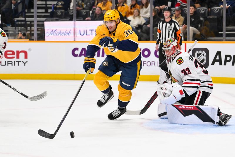 Jan 10, 2026; Nashville, Tennessee, USA;  Chicago Blackhawks goaltender Drew Commesso (33) blocks the shot of Nashville Predators left wing Cole Smith (36) during the first period at Bridgestone Arena. Mandatory Credit: Steve Roberts-Imagn Images