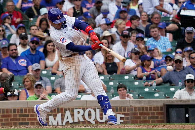 Jul 7, 2024; Chicago, Illinois, USA; Chicago Cubs catcher Miguel Amaya (9) hits a double against the Los Angeles Angels during the fifth inning at Wrigley Field. Mandatory Credit: David Banks-USA TODAY Sports