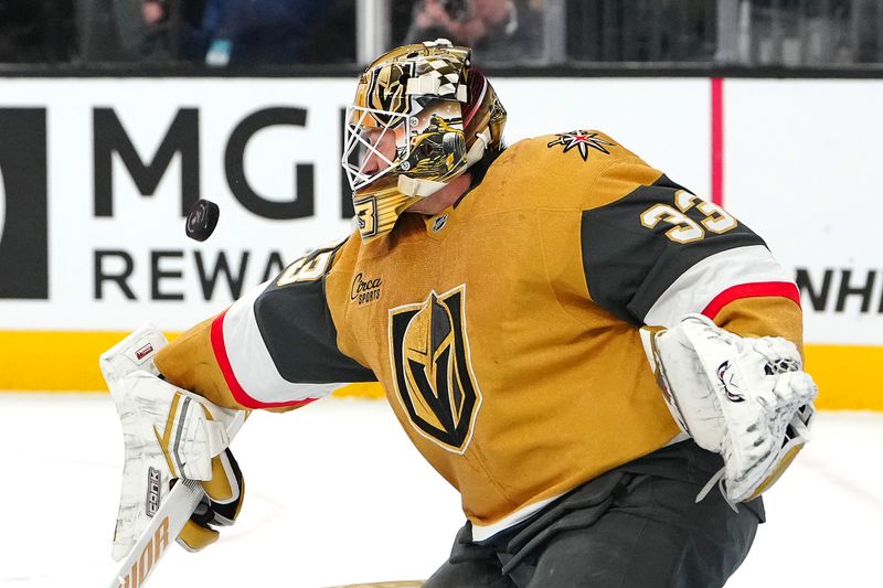 Dec 3, 2024; Las Vegas, Nevada, USA; Vegas Golden Knights goaltender Adin Hill (33) makes a save against the Edmonton Oilers during the first period at T-Mobile Arena. Mandatory Credit: Stephen R. Sylvanie-Imagn Images