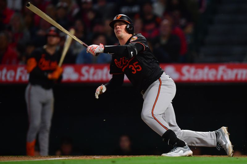 Apr 23, 2024; Anaheim, California, USA; Baltimore Orioles catcher Adley Rutschman (35) hits a single against the Los Angeles Angels during the seventh inning at Angel Stadium. Mandatory Credit: Gary A. Vasquez-USA TODAY Sports