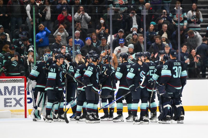 Nov 12, 2024; Seattle, Washington, USA; The Seattle Kraken celebrate after defeating the Columbus Blue Jackets at Climate Pledge Arena. Mandatory Credit: Steven Bisig-Imagn Images