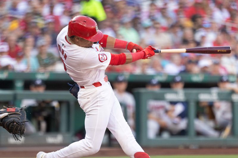 Jun 26, 2024; St. Louis, Missouri, USA; St. Louis Cardinals shortstop Masyn Winn (0) hits a base hit as St. Louis Cardinals outfielder Michael Siani (not pictured) advances to third base against the Atlanta Braves in the third inning at Busch Stadium. Mandatory Credit: Zach Dalin-USA TODAY Sports