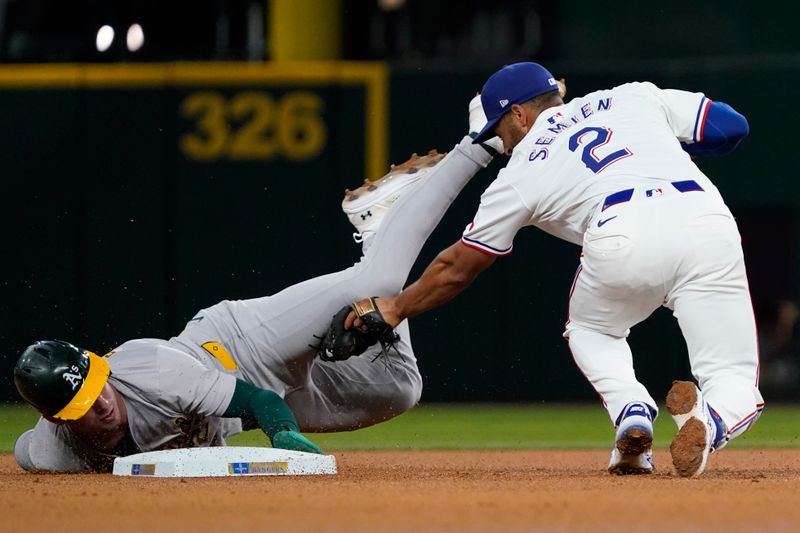 Aug 31, 2024; Arlington, Texas, USA; Oakland Athletics left fielder Brent Rooker (25) steals second base as Texas Rangers second baseman Marcus Semien (2) applies the tag late during the fourth inning at Globe Life Field. Mandatory Credit: Raymond Carlin III-USA TODAY Sports