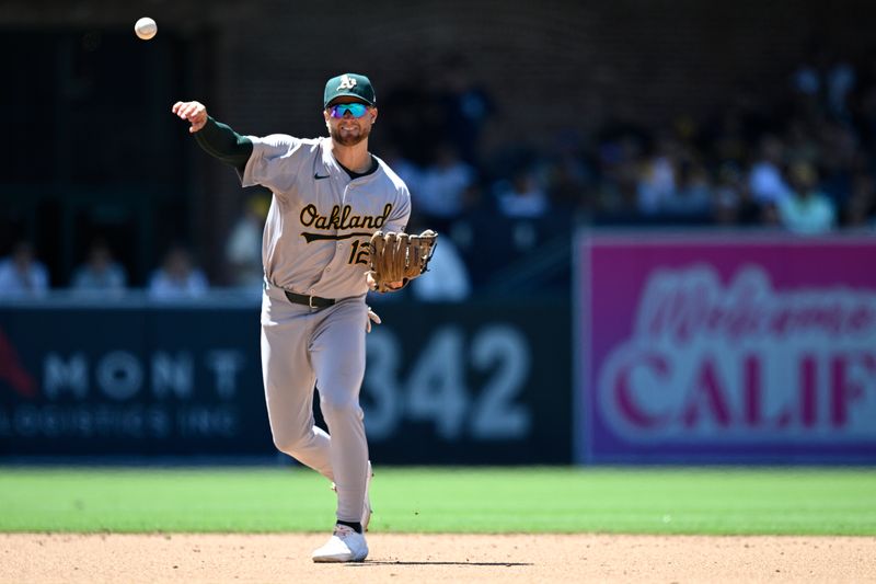 Jun 12, 2024; San Diego, California, USA; Oakland Athletics shortstop Max Schuemann (12) throws to first base on a ground out by San Diego Padres catcher Luis Campusano (not pictured) during the fifth inning at Petco Park. Mandatory Credit: Orlando Ramirez-USA TODAY Sports