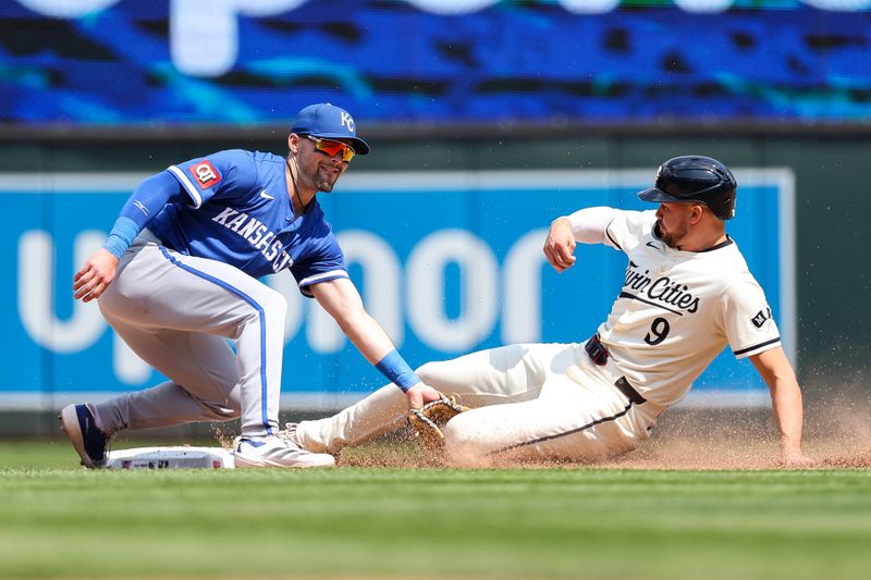 May 25, 2025; Minneapolis, Minnesota, USA; Kansas City Royals second baseman Michael Massey (19) tags out Minnesota Twins outfielder Trevor Larnach (9) on a steal attempt during the eighth inning at Target Field. Mandatory Credit: Matt Krohn-Imagn Images