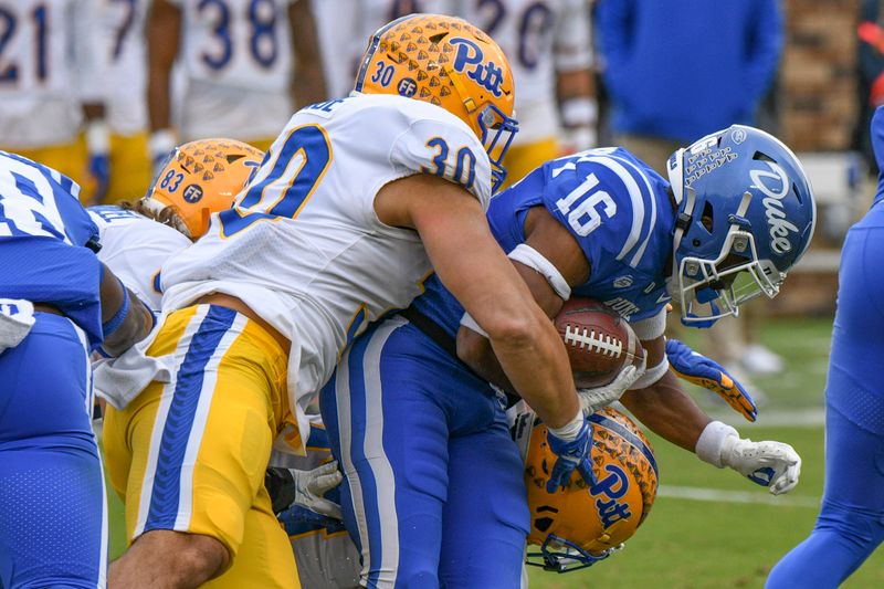 Nov 6, 2021; Durham, North Carolina, USA;  Duke Blue Devils safety Jaylen Stinson (16) is tackled on a return by Pittsburgh Panthers linebacker Brandon George (30) during the second quarter at Wallace Wade Stadium. Mandatory Credit: William Howard-USA TODAY Sports