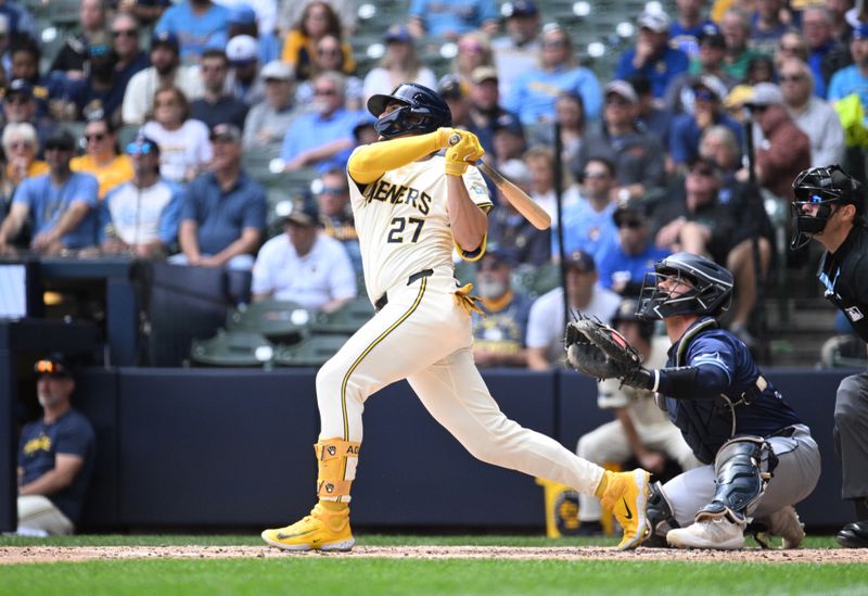 May 1, 2024; Milwaukee, Wisconsin, USA; Milwaukee Brewers shortstop Willy Adames (27) hits a home run against the Tampa Bay Rays in the sixth inning at American Family Field. Mandatory Credit: Michael McLoone-USA TODAY Sports
