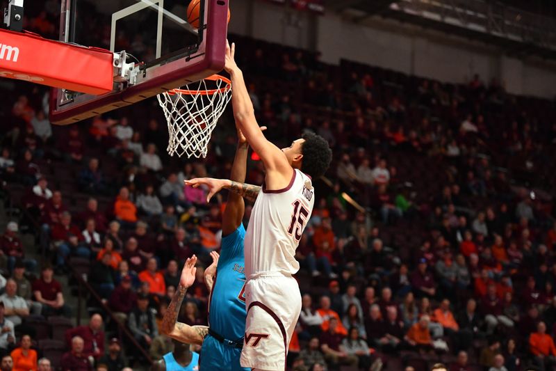 Feb 13, 2024; Blacksburg, Virginia, USA; Virginia Tech Hokies center Lynn Kidd (15) .lays it up over a Florida State Seminoles defender during the second half at Cassell Coliseum. Mandatory Credit: Brian Bishop-USA TODAY Sports