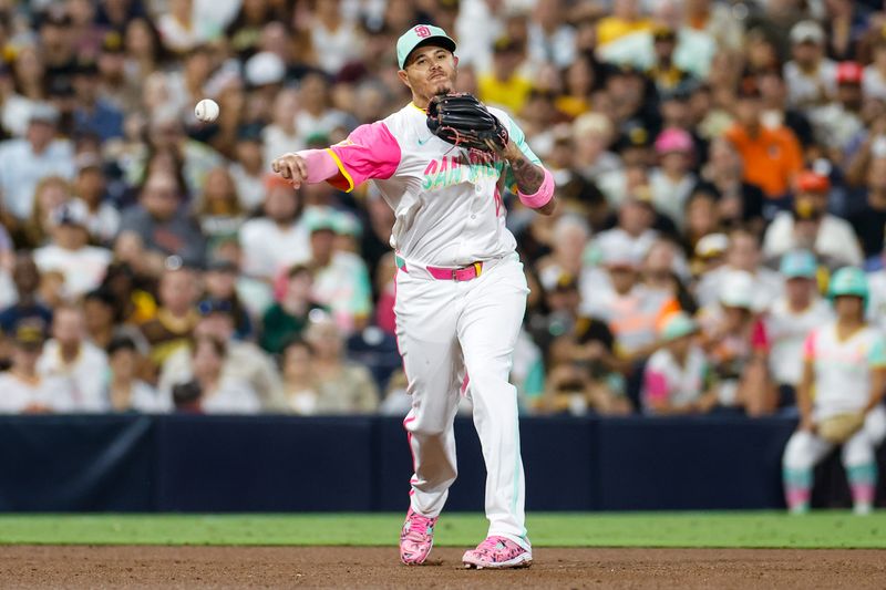 Sep 6, 2024; San Diego, California, USA; San Diego Padres third basemen Manny Machado (13) makes the throw to first for an out during the sixth inning against the San Francisco Giants at Petco Park. Mandatory Credit: David Frerker-Imagn Images