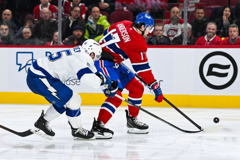 Jan 21, 2025; Montreal, Quebec, CAN;Tampa Bay Lightning defenseman Maxwell Crozier (65) defends the puck against Montreal Canadiens right wing Josh Anderson (17)  during the third period at Bell Centre. Mandatory Credit: David Kirouac-Imagn Images