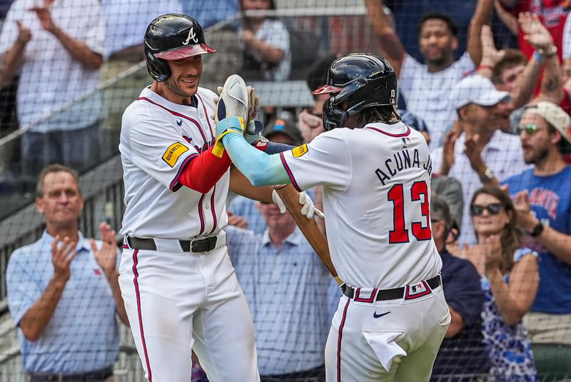 Apr 26, 2024; Cumberland, Georgia, USA; Atlanta Braves right fielder Ronald Acuna Jr (13) reacts with first baseman Matt Olson (28) after scoring the game winning run against the Cleveland Guardians during the tenth inning at Truist Park. Mandatory Credit: Dale Zanine-USA TODAY Sports