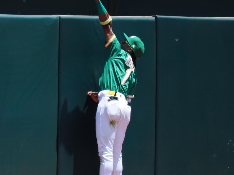 Jun 29, 2023; Oakland, California, USA; Oakland Athletics center fielder Esteury Ruiz (1) loses his glove over the wall trying to catch a ball, resulting in a New York Yankees home run during the second inning at Oakland-Alameda County Coliseum. Mandatory Credit: Kelley L Cox-USA TODAY Sports